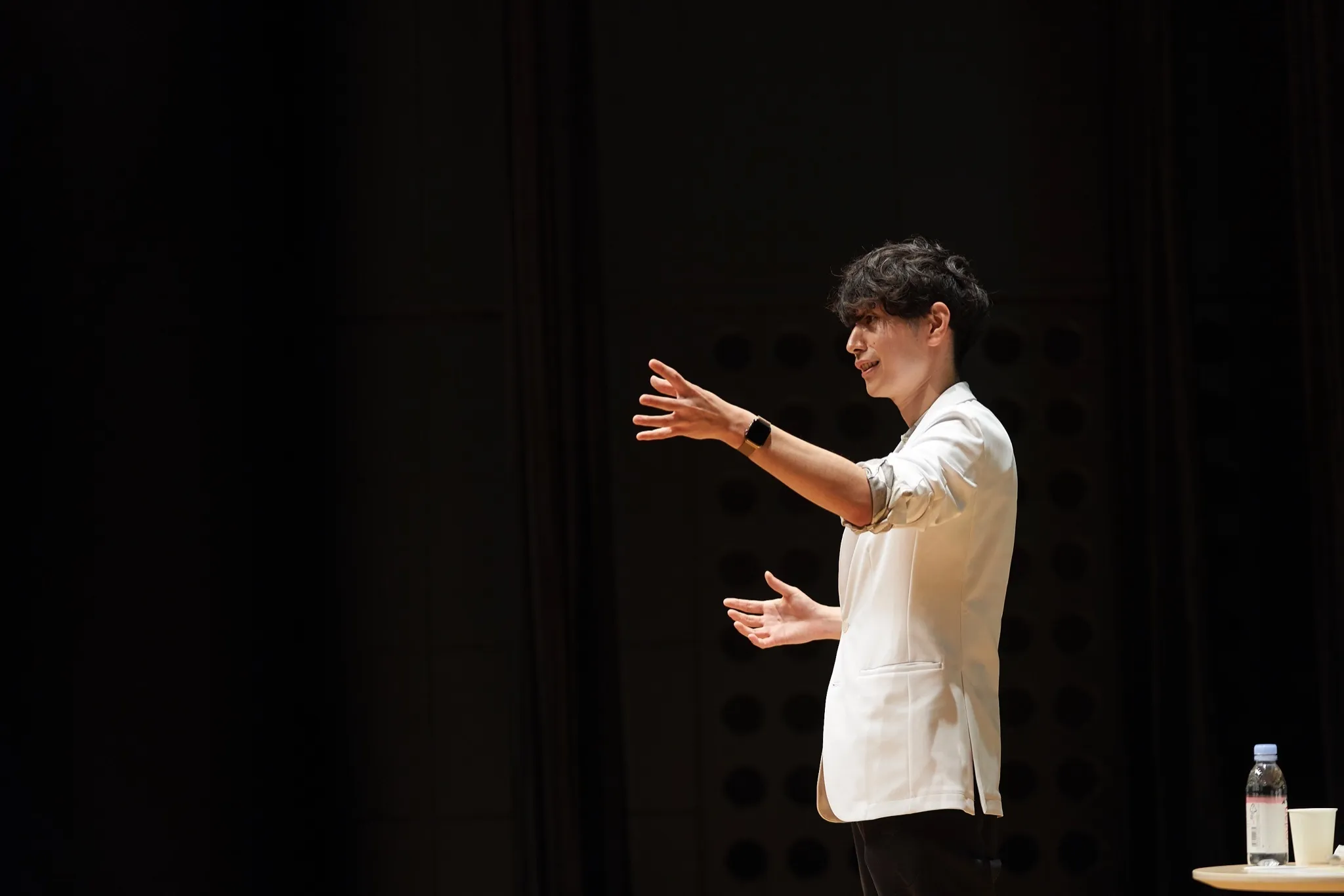 講演会場で身振りを交えて話す志村祥瑚